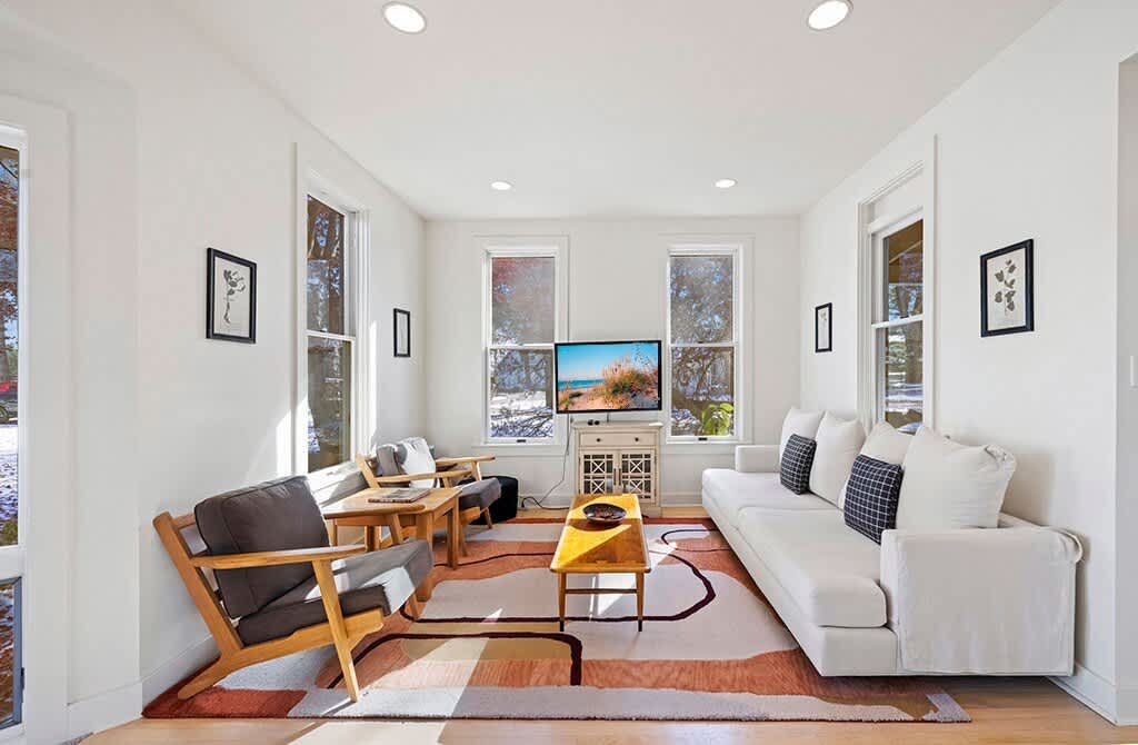 Windows, sunshine, and relaxed living at The Farmhouse.