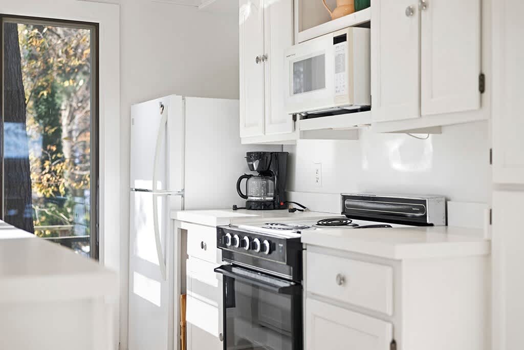 Morning light brightens The Cottage’s simple, well-equipped kitchen.