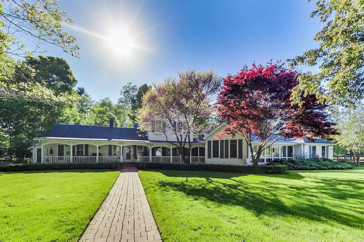 The Farmhouse glows at sunrise, inviting you into pure country calm.