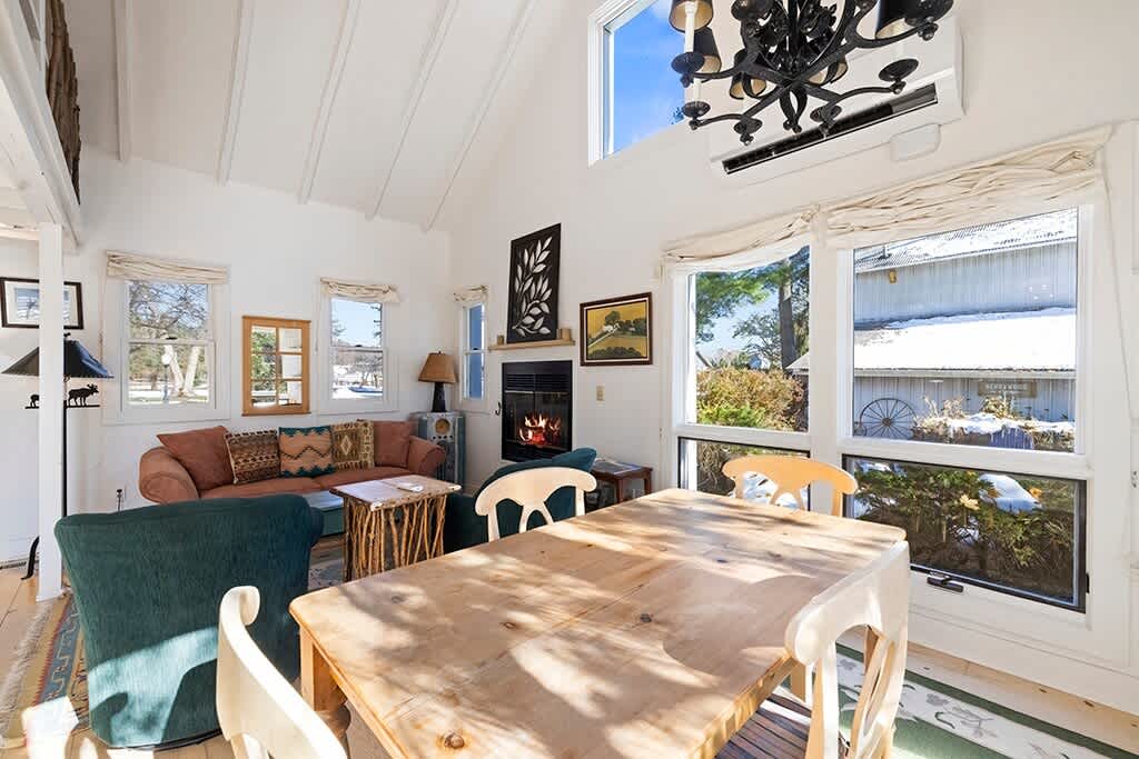 Meals and fireside chats flow together in The Cottage’s open, sunny layout.