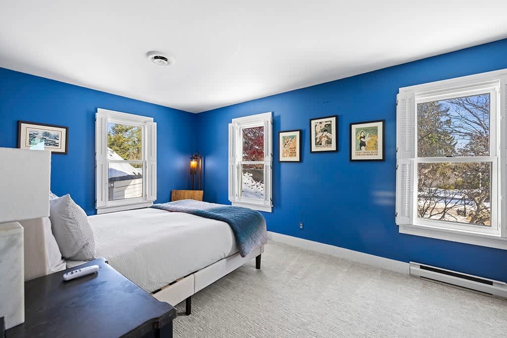 Sun-filled blue bedroom offering calm mornings at The Farmhouse.