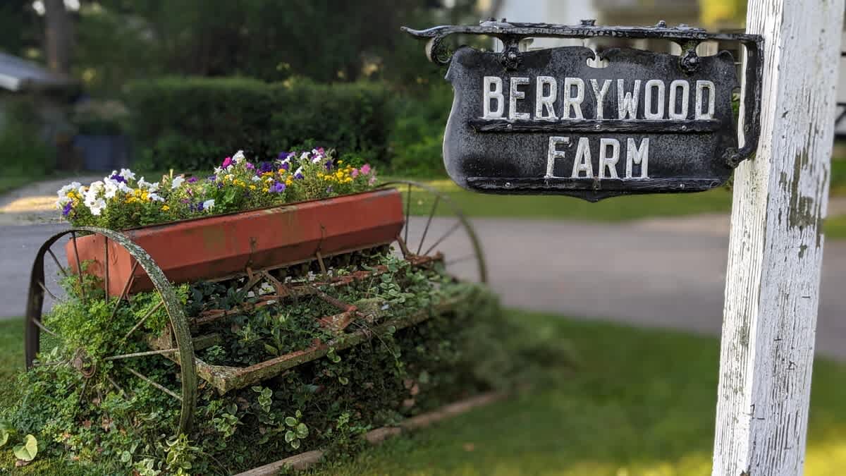 Snap a photo by Berrywood Farm’s vintage flower cart and charming sign.