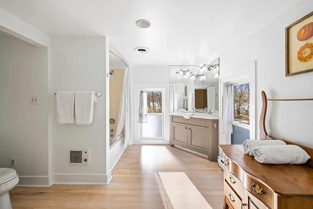 A wide, light-filled bathroom designed for calm, unhurried routines.
