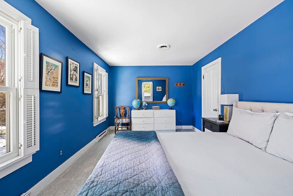 Bedroom 4 in The Farmhouse is on the upper level and has a queen-size bed.