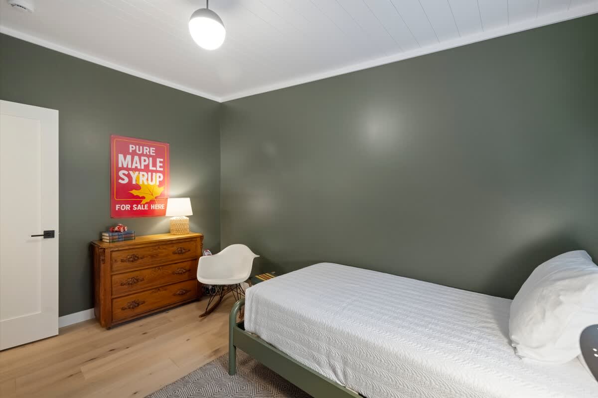 A warm single room with vintage charm and woodland tones.