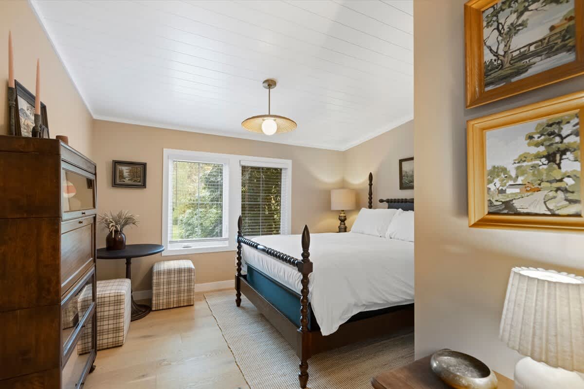 A bright bedroom blending comfort and classic design.
