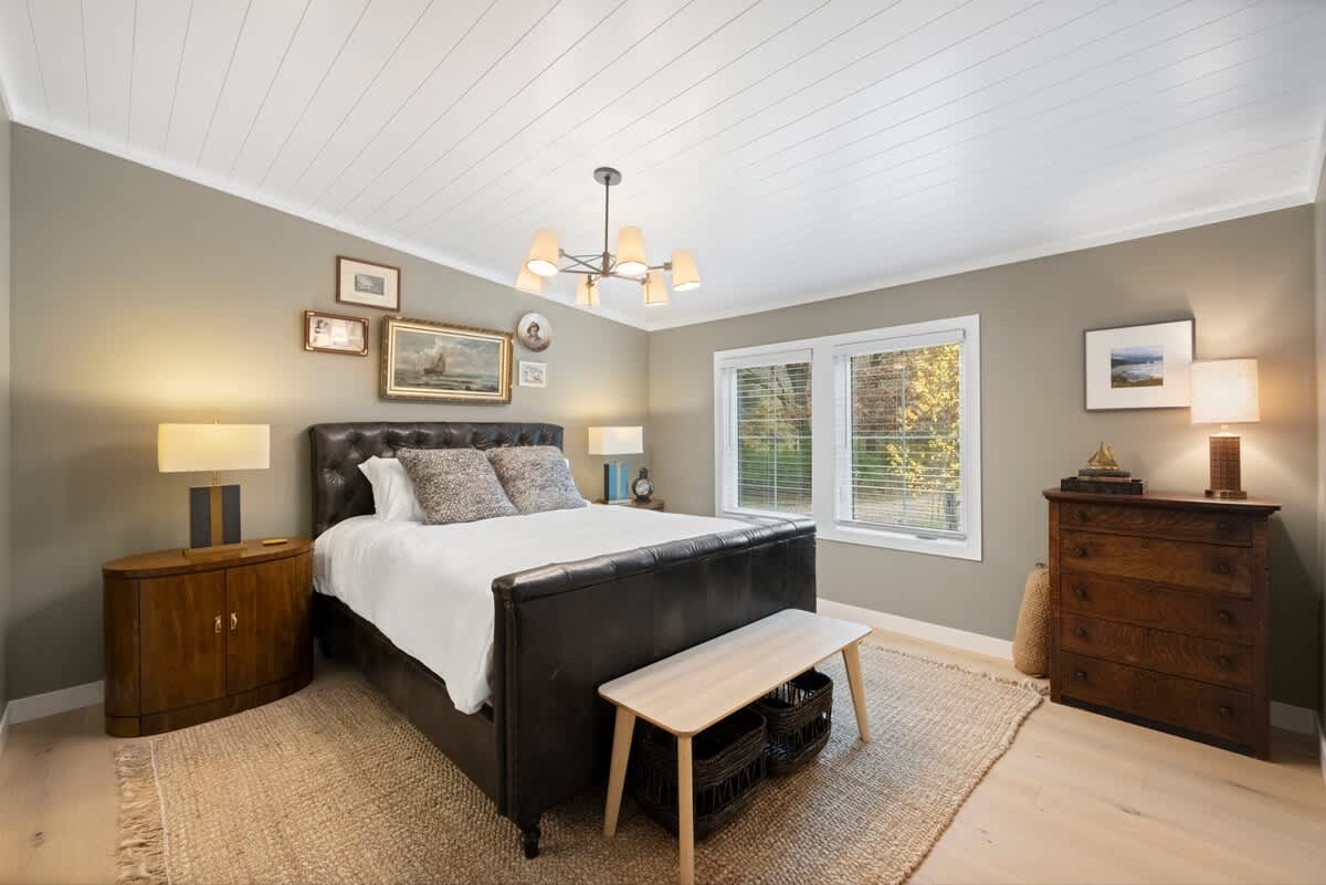 Spacious main bedroom with private bath and natural light.