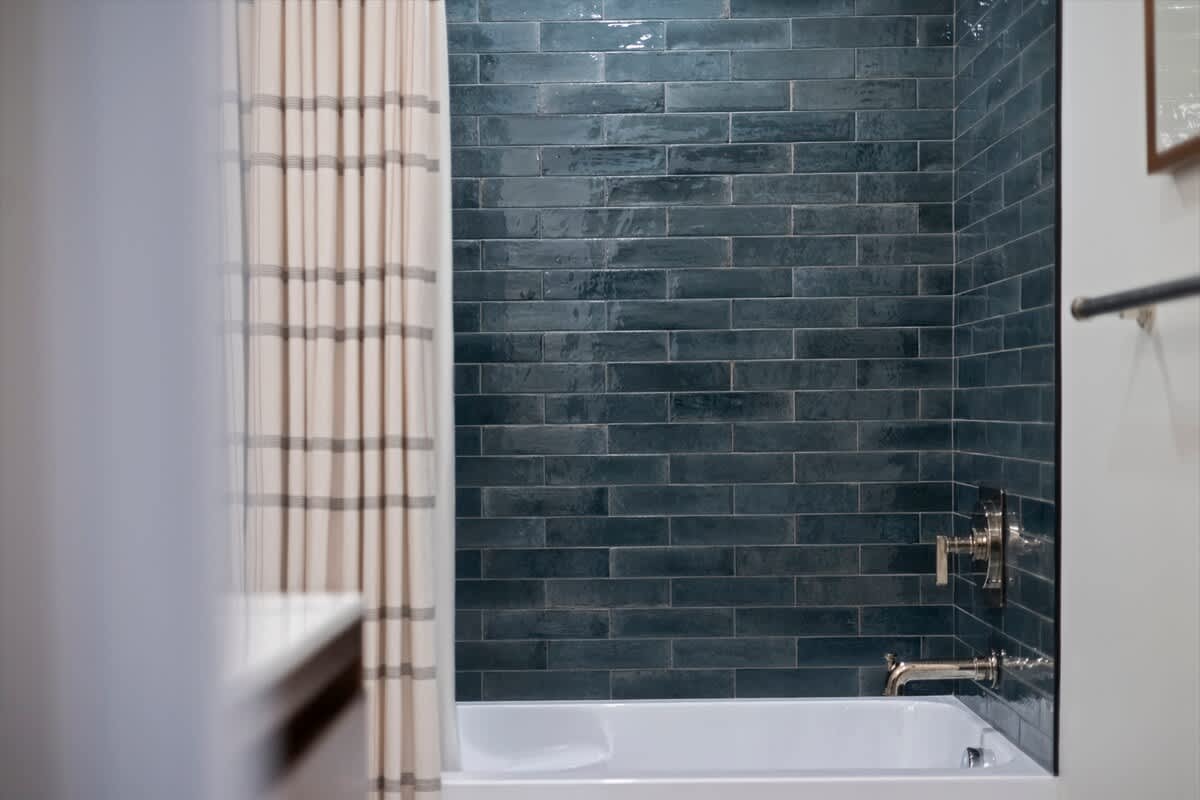 Rich aquamarine tones create a calm, modern bath retreat.