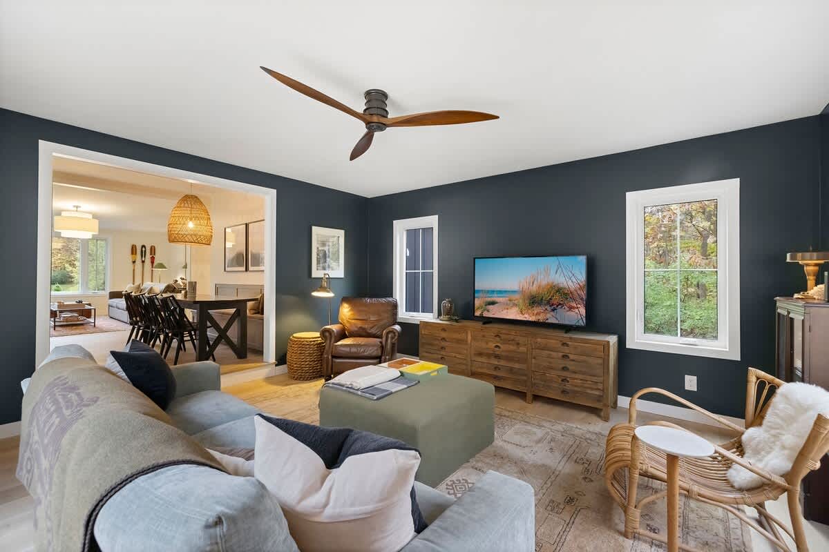The den flows into dining, connecting calm and conversation.
