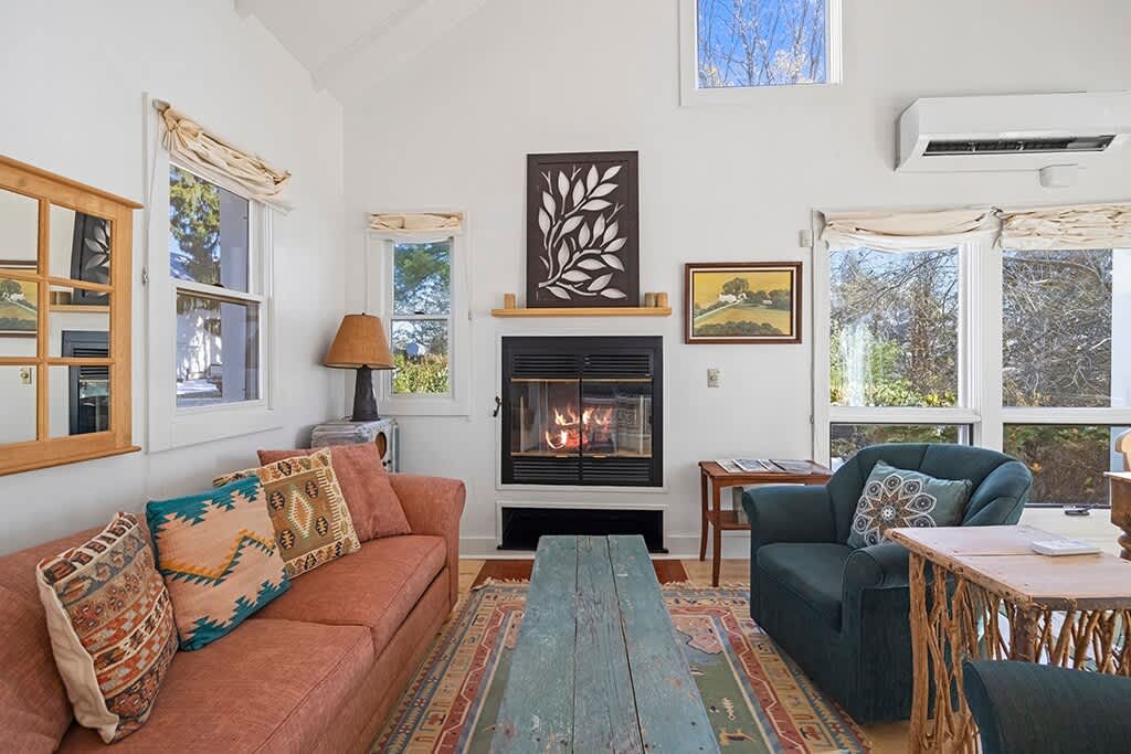 A cozy corner of The Cottage designed for unwinding by the fireplace.