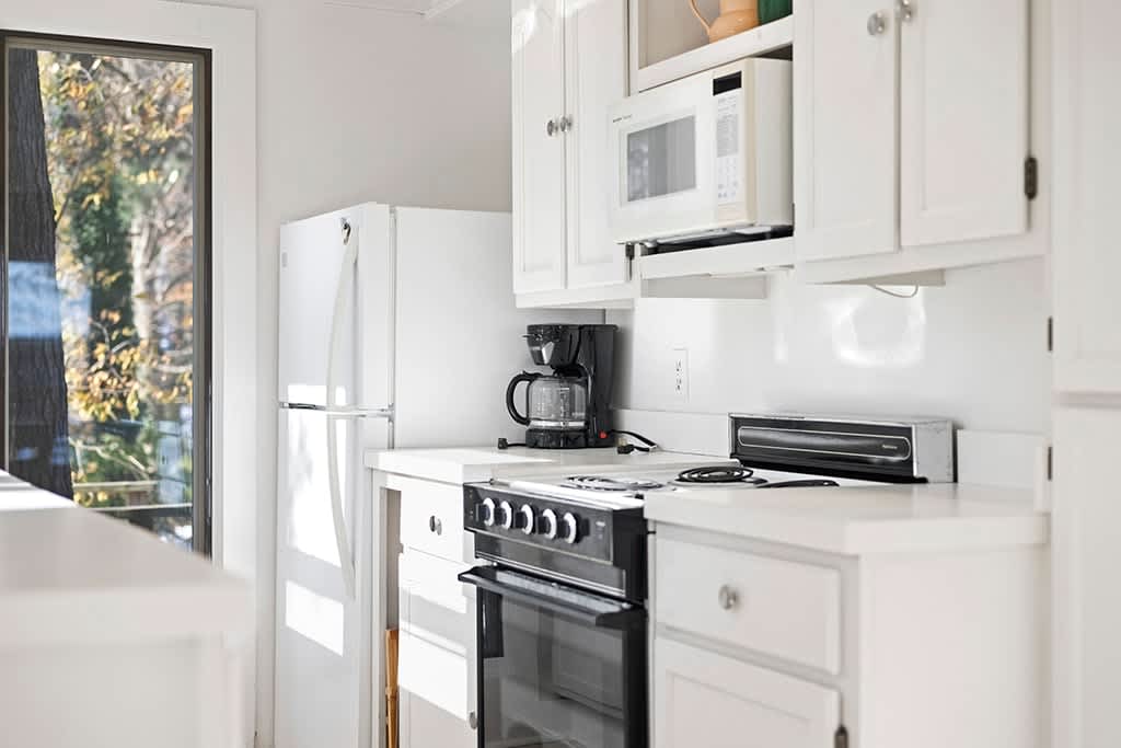 Morning light brightens The Cottage’s simple, well-equipped kitchen.