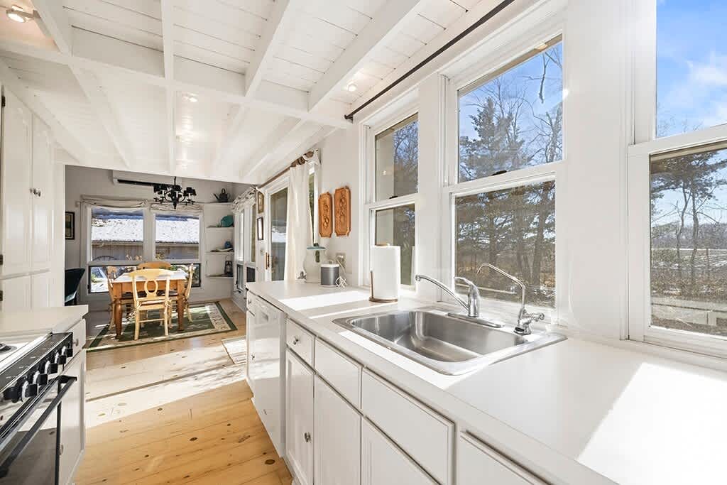 Sunlit counters lead to an inviting dining nook at the heart of The Cottage.
