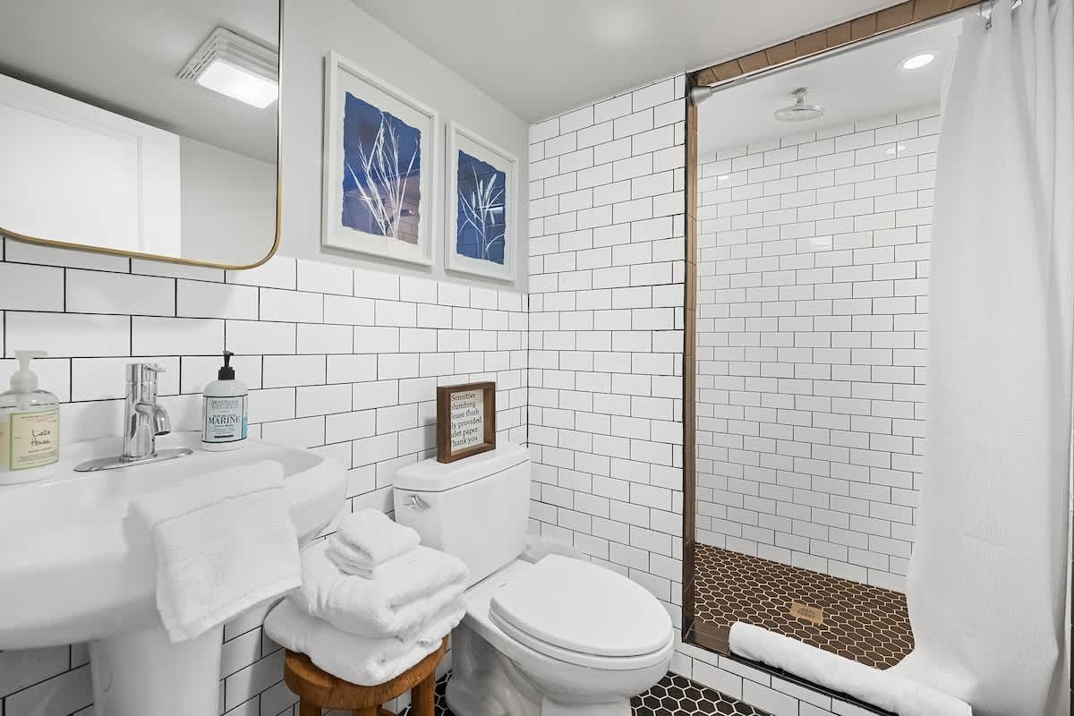 A contemporary bath with a large shower, perfect for resetting after the day.