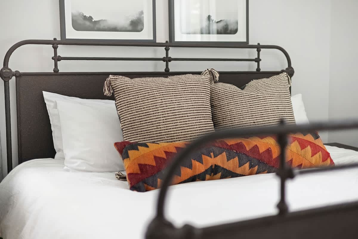 A warm, welcoming bedroom with artful touches throughout.