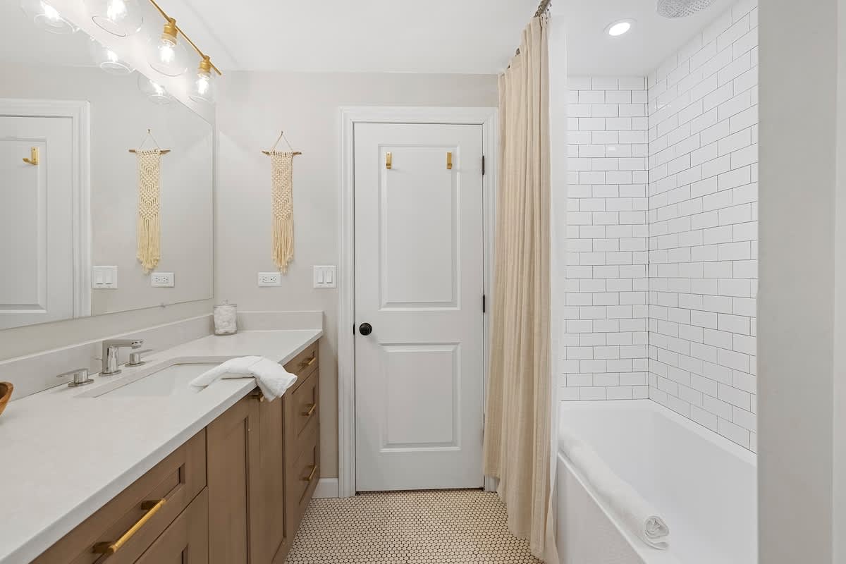 Clean, modern finishes elevate the primary bedroom’s private bath.