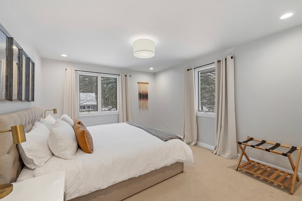 Every bedroom is elevated with supreme linens and lovely forest views.