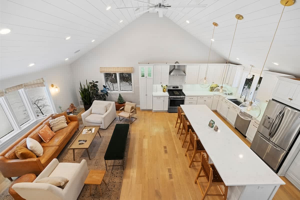 A sweeping view of the home’s warm, welcoming living and kitchen spaces.