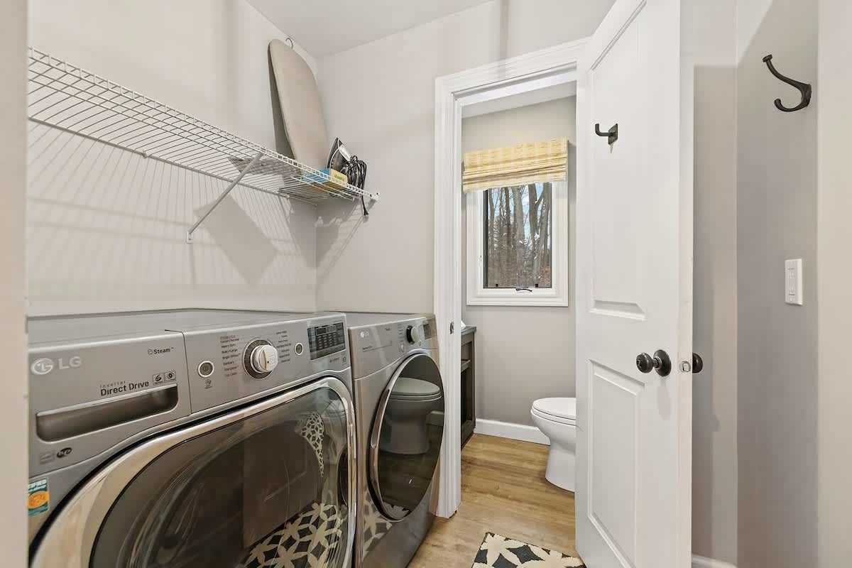 Our tidy laundry space has a bonus half bath for added convenience.