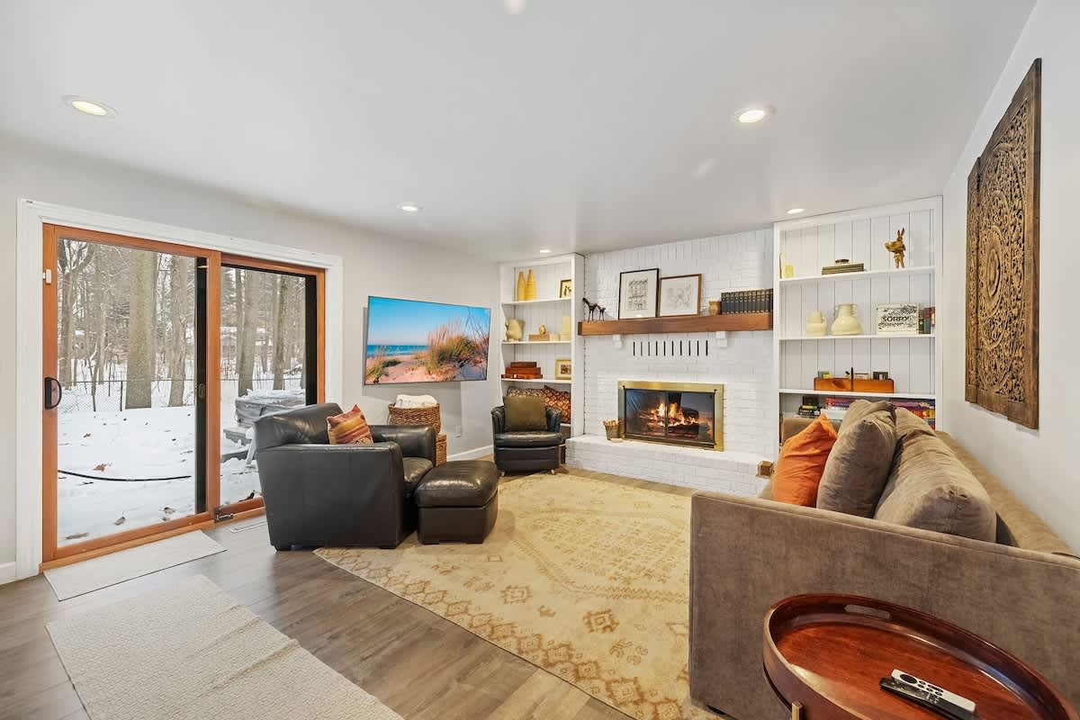 Settle in by the fire with woodland views just beyond the glass.