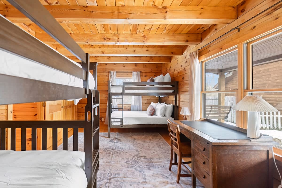 Bedroom 2 is on the main level with 2 full bunkbeds and dedicated workspace.