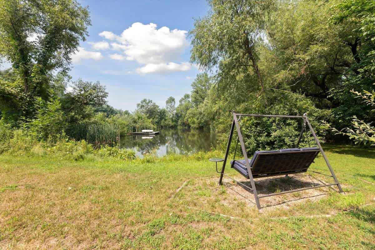 Swing gently beside your private pond.