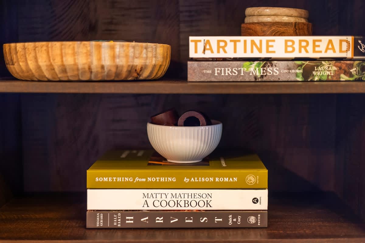 Inspiring cookbooks and serving pieces for cabin dinners.