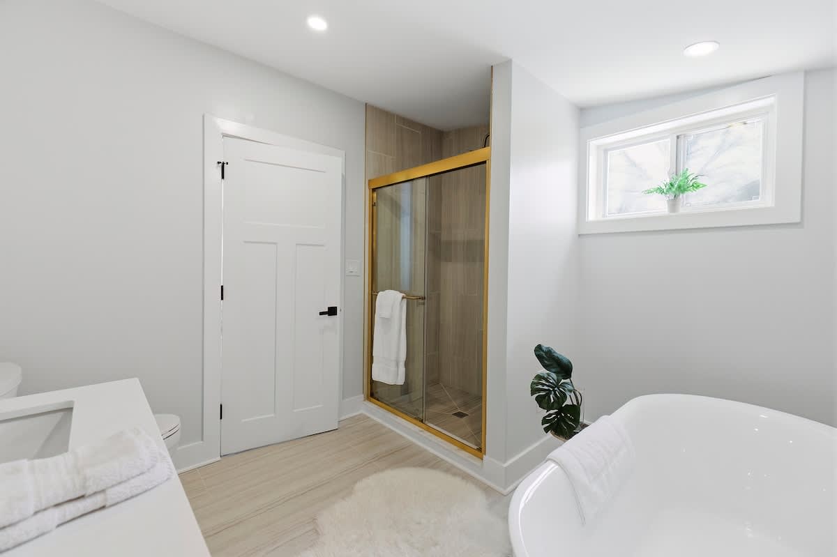 The primary bath pairs a soaking tub with a spacious shower.