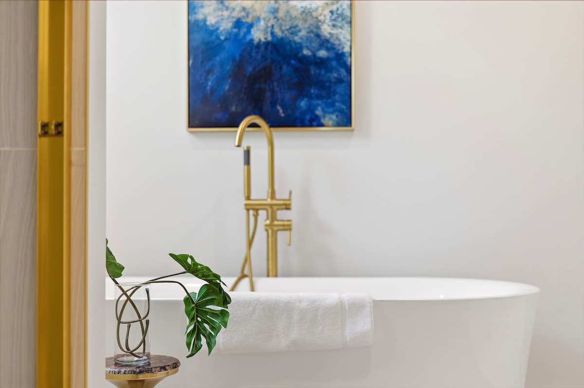Treat yourself to a long, relaxing bath in this elegant modern suite.