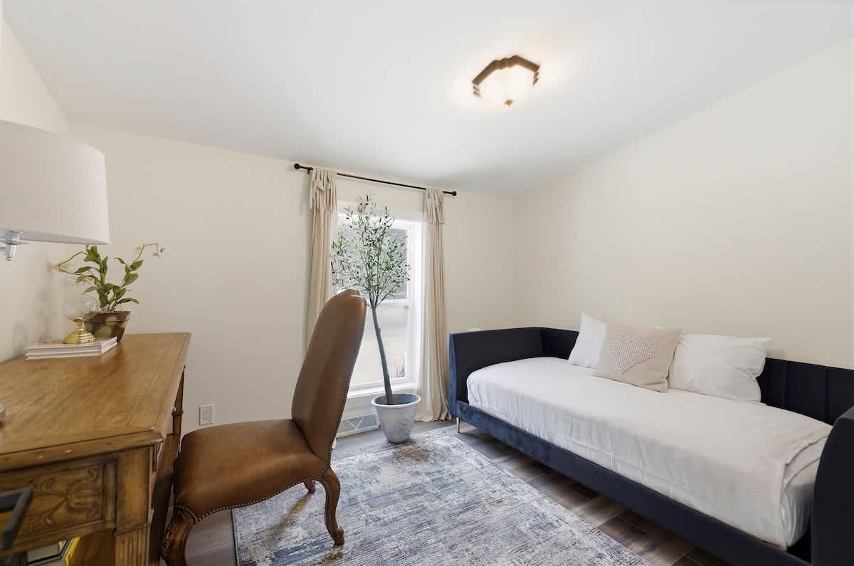 Bedroom 5 offers a quiet dedicated desk and a comfortable daybed.