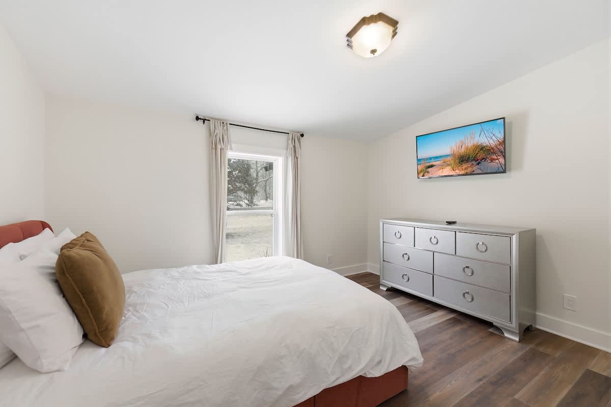 A bright guest bedroom with space to unpack and settle in.