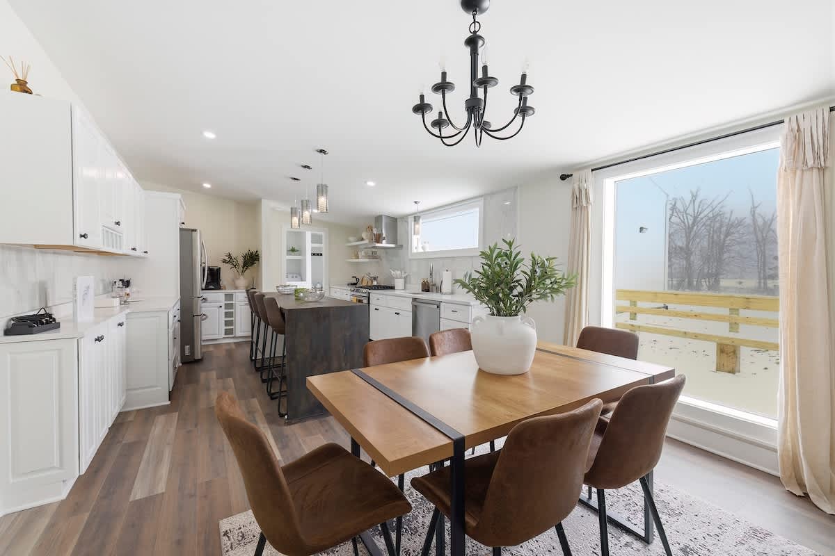 Dining for six beside the kitchen, with island seating just beyond.