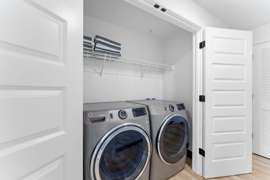 Downstairs laundry room with oversized front-loaders