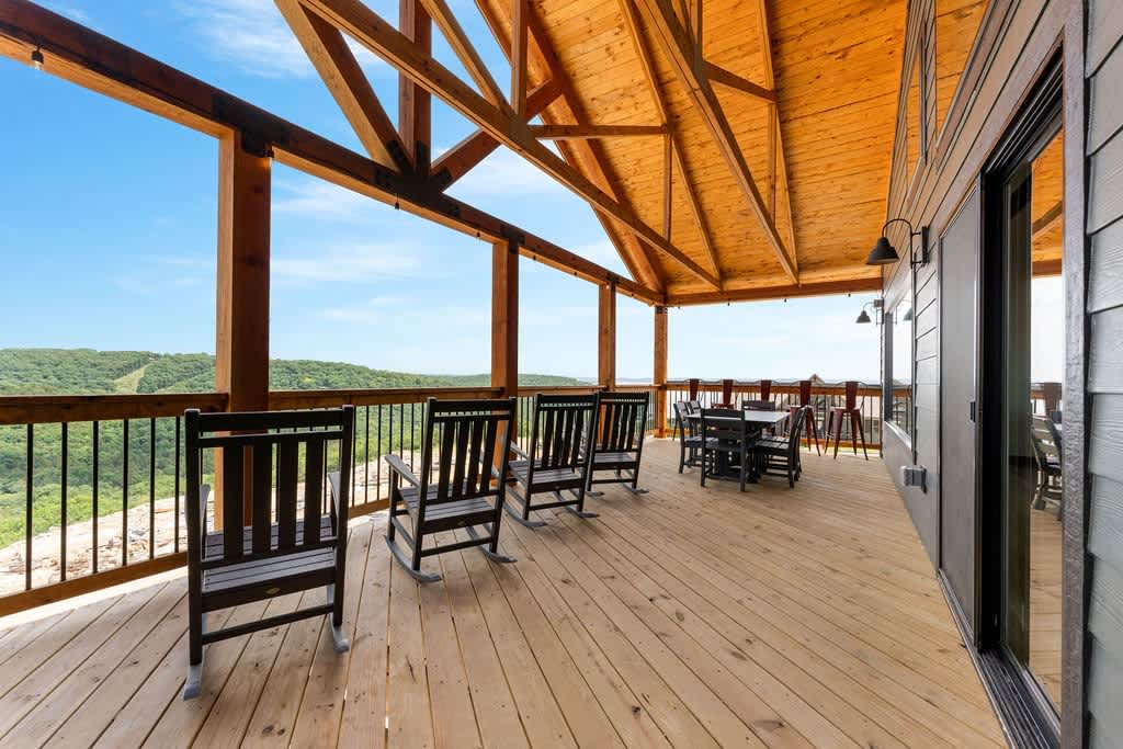 Main (Upper Level) Deck - plenty of places to sit and enjoy the sunrise or sunset, outdoor dining area, and bar stools with a drink rail to hang and enjoy the lake view!