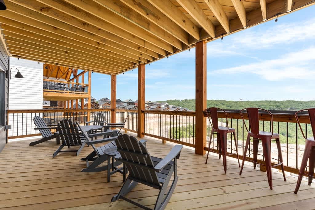 The lower deck also has some great hang areas with the patio furniture, some rockers, and drink rails next to the hot tub to hang with the people that are getting a soak!
