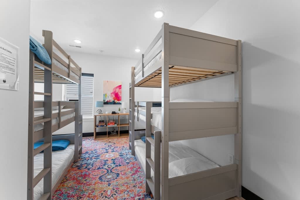 Bunk room with six (6) twin beds!   Comes with a shelf full of games, too.  This room also has a multi-device charger for all the smart phones.  And...of course, a white noise machine.