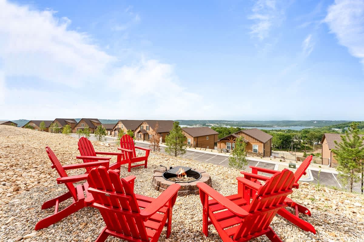 Outdoor fire pit is available for your enjoyment with these memorable red adirondack chairs!  Take in the incredible view of the lake and bridge while you enjoy the sunset!