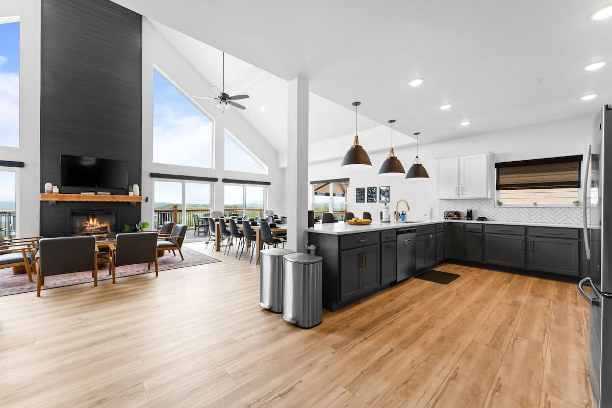 Extremely open kitchen/dining/living room area with vaulted ceilings.