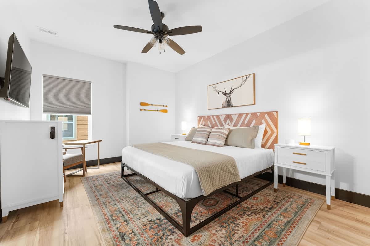 Downstairs Bedroom (King) with attached bathroom and lounge chair / computer desk