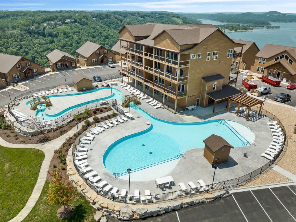 Community Outdoor Pool with a LAZY RIVER!   Indoor pools are located in the first level of the building in this photo.