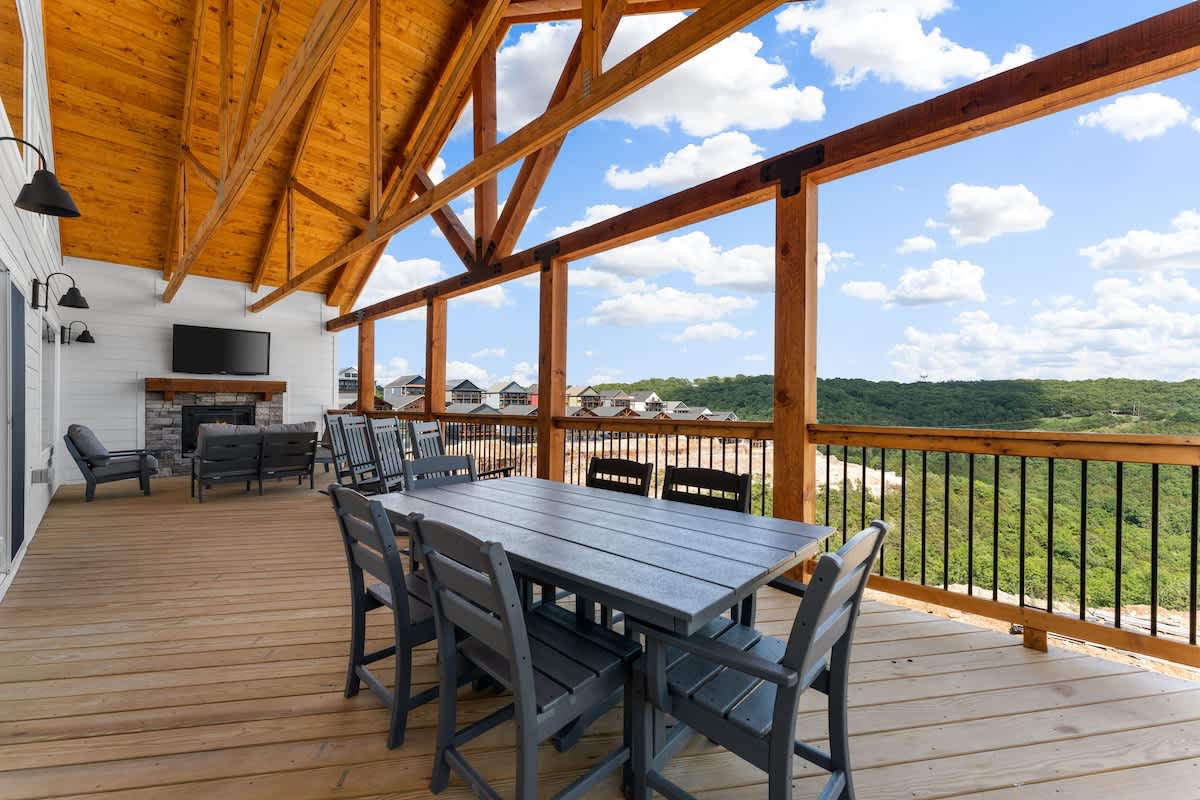 Top deck with outdoor TV, sitting area, and dining table