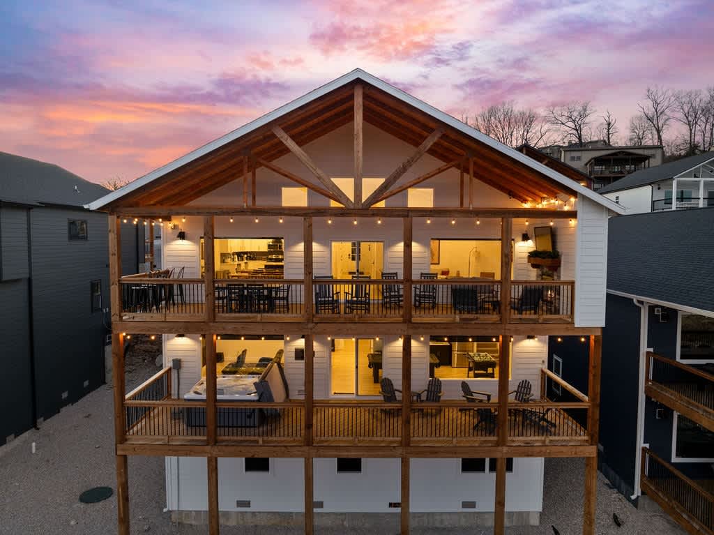 Two back decks with plenty of outdoor seating, outdoor TV, and hot tub