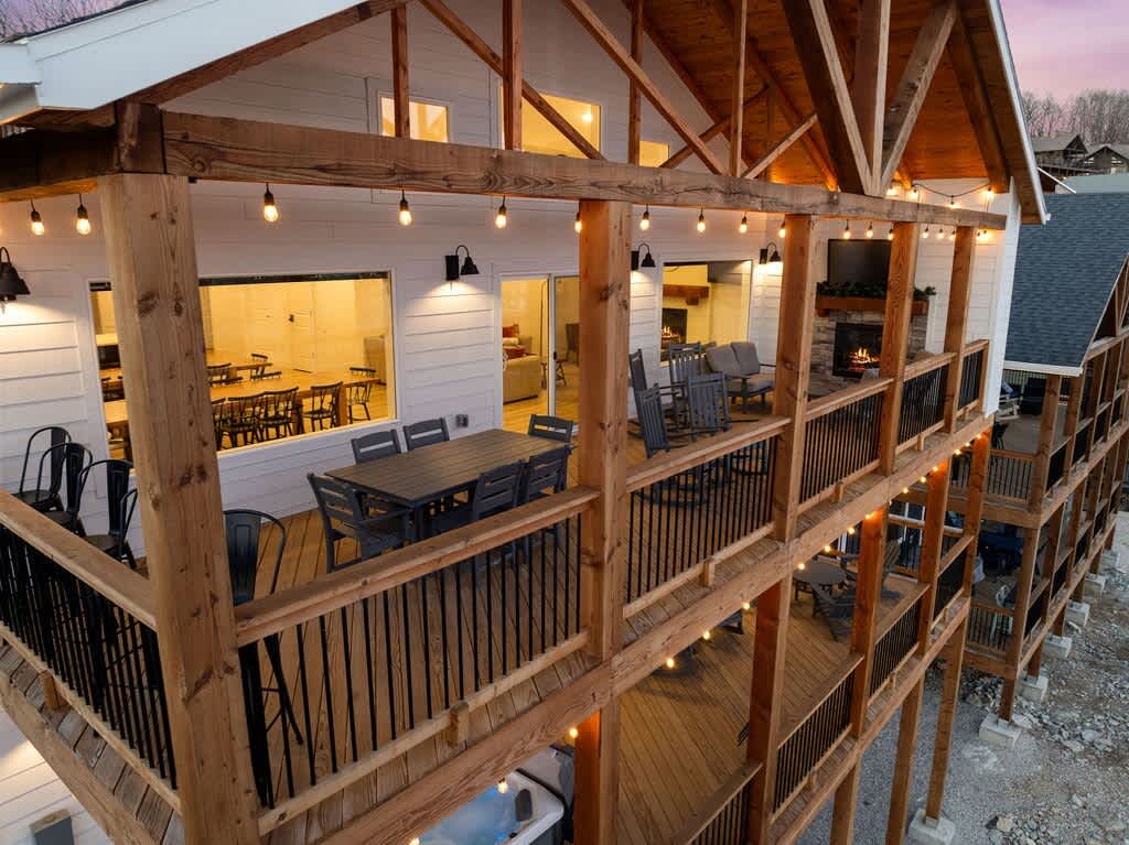 Upper Back Deck with Outdoor Dining, Rocking Chairs, Bar Stools with a view, and a outdoor TV with a sitting area