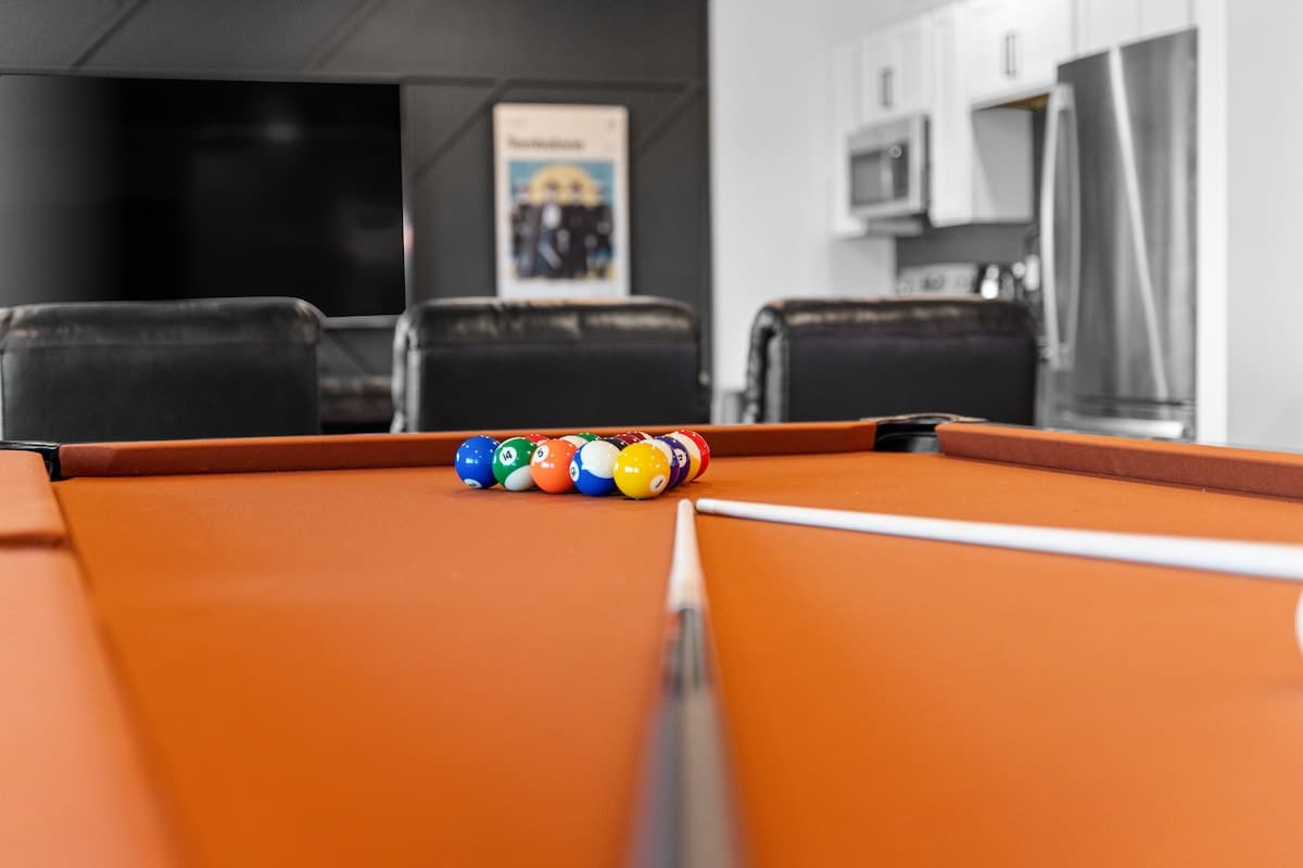 Pool Table looking onto the 85" TV with reclining theater seats