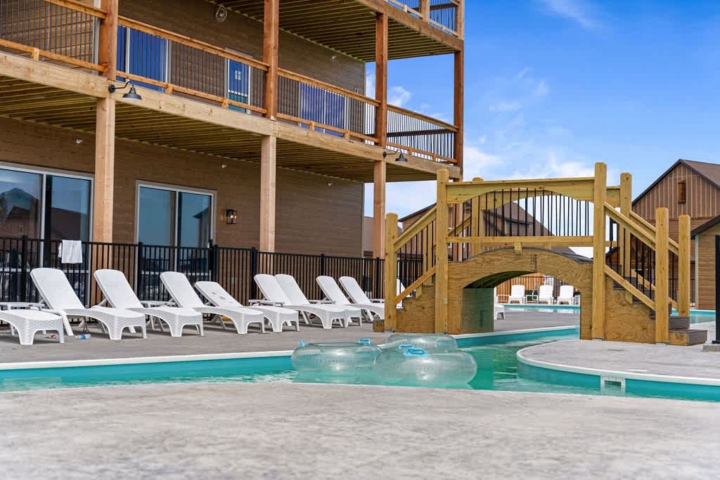 Lazy River feeding into the main Outdoor Pool. The Heated Community Indoor Pool, Community Center, and Arcade Room is the building on the left