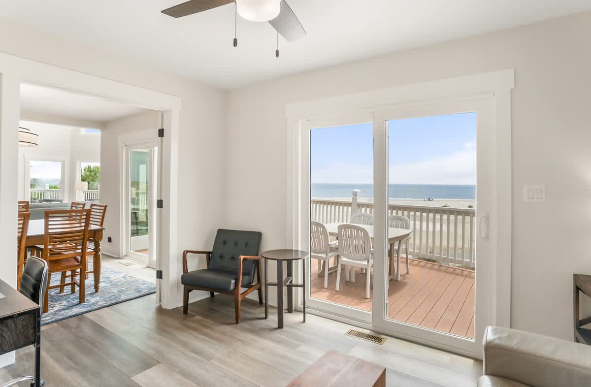 A Cozy Study with a Sofa and Desk Along with Washer and Dryer 