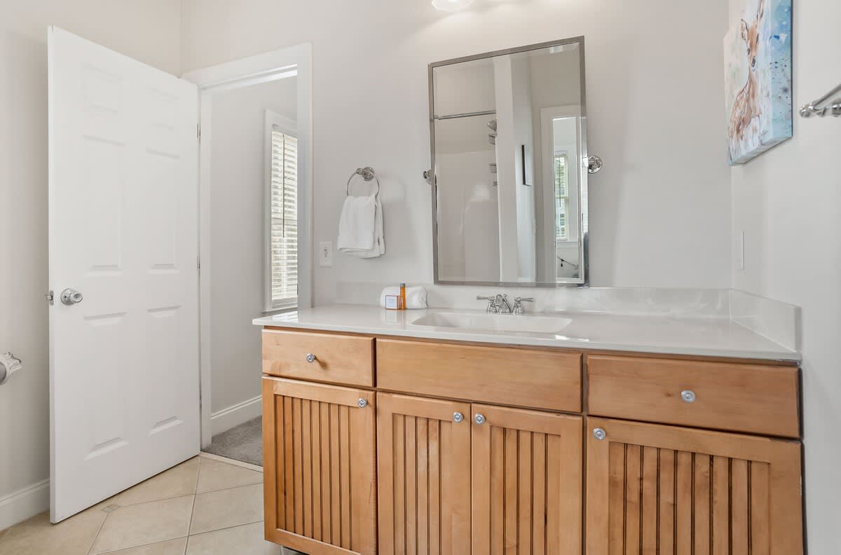 A Shared Jack-and-Jill Bathroom with a Shower-Tub Combo. 