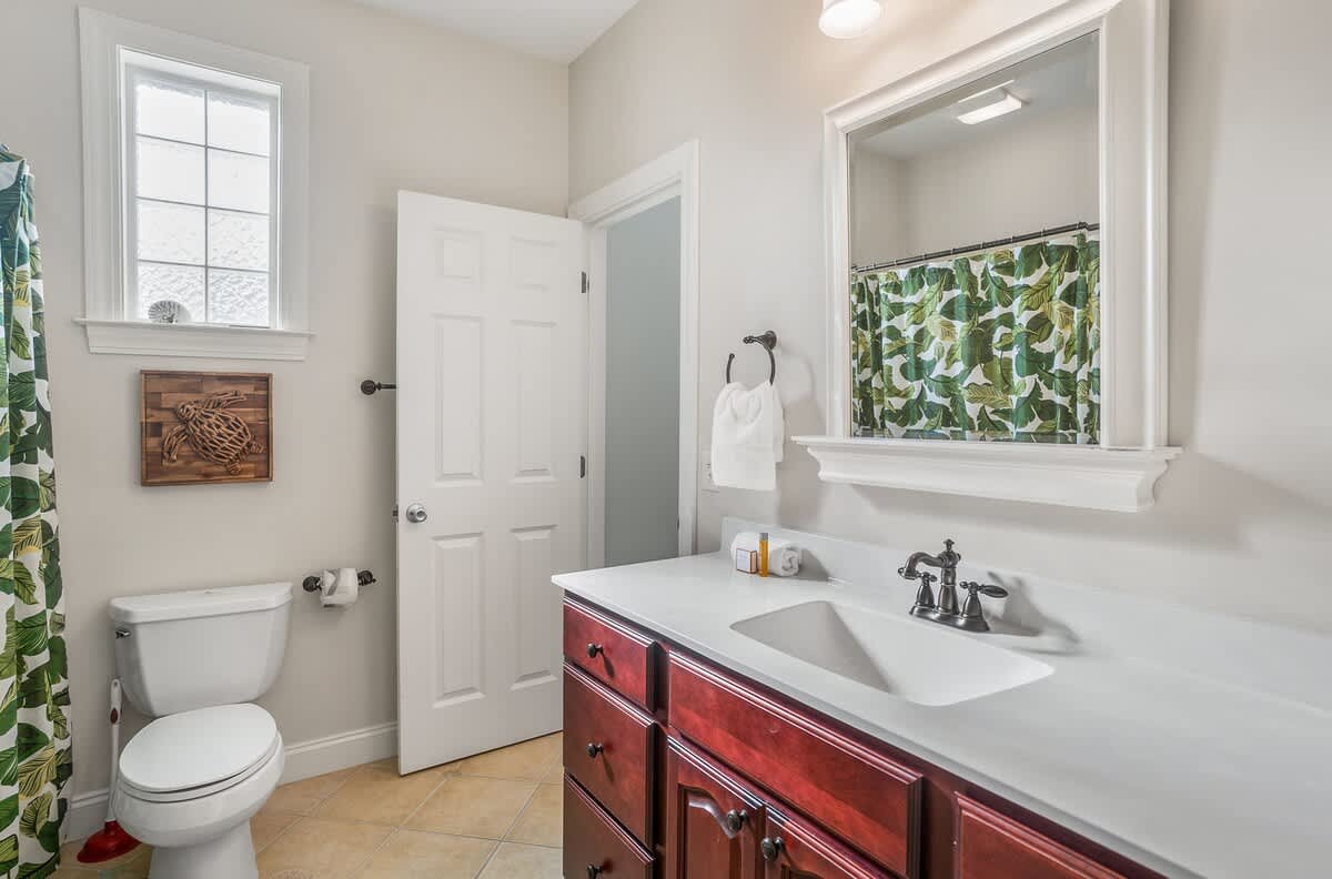 Attached Bathroom to Queen Bedroom with a Shower-Tub Combo with Convenient Hallway Access.