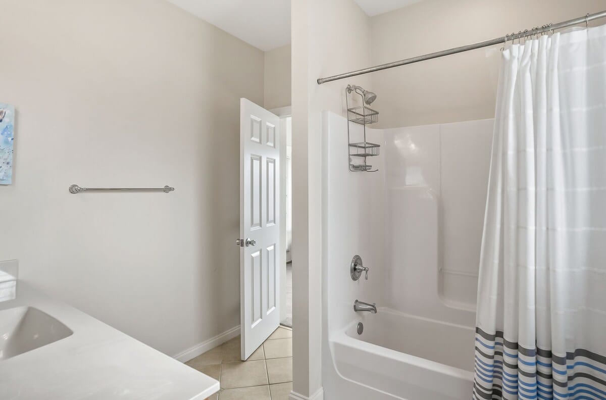 A Shared Jack-and-Jill Bathroom with a Shower-Tub Combo. 