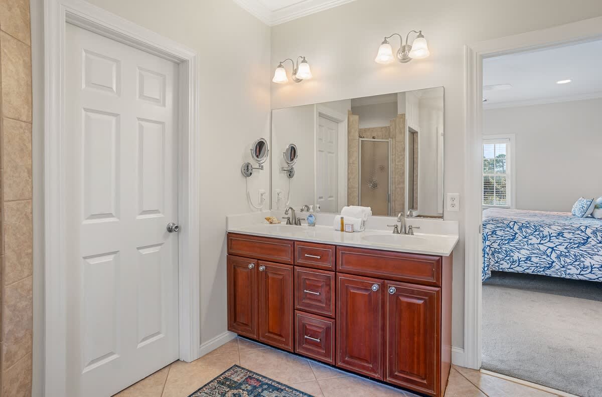 Queen Bed with Streaming TV, Private Balcony, and a Shared Jack-and-Jill Bathroom with a Shower-Tub Combo. 