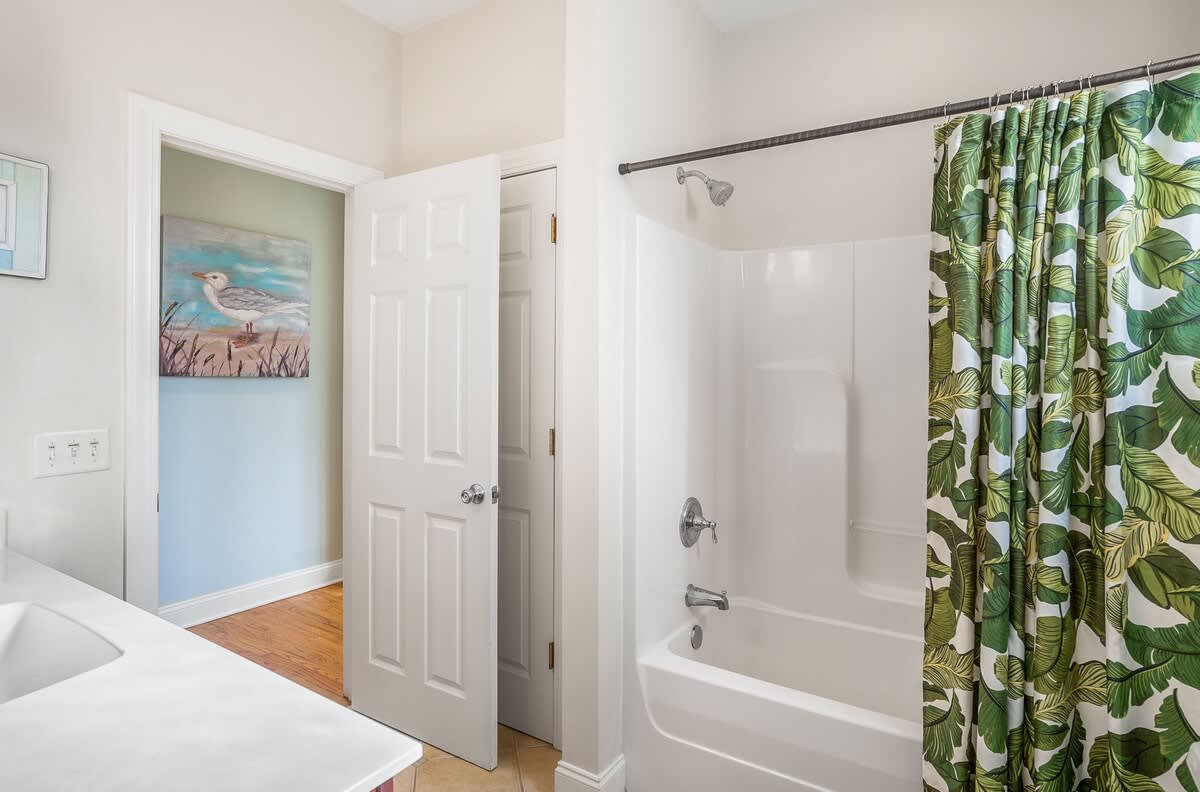 Attached Bathroom to Queen Bedroom with a Shower-Tub Combo with Convenient Hallway Access.